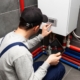 A technician checking on the status of a water heater