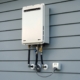 Closeup of a tankless water heater on a home's exterior