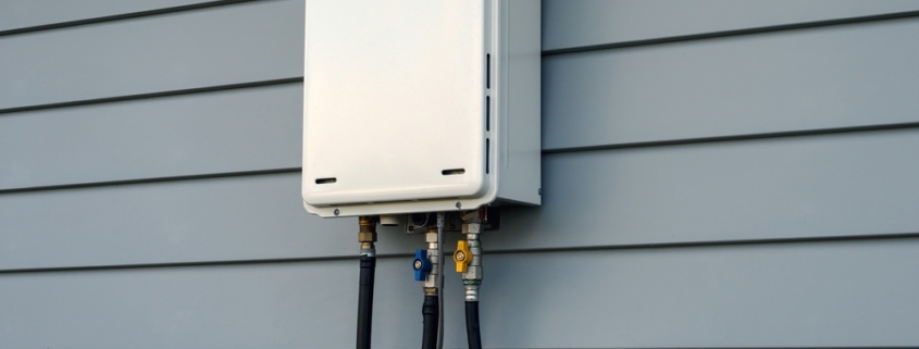 Closeup of a tankless water heater on a home's exterior